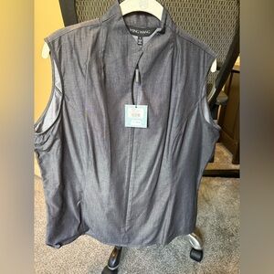 Sleeveless black mandarin collar zipper front blouse.